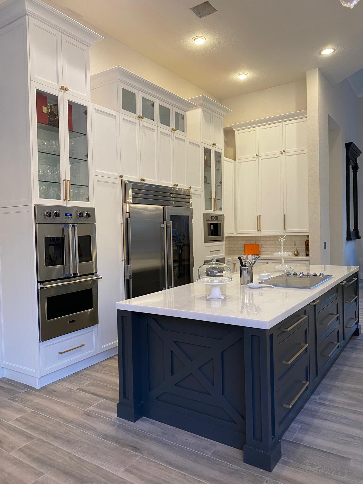 Parkland Kitchen — vertical wood grain cabinetry with marble counters and island